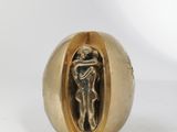 an image of a gold ring with a statue inside of it