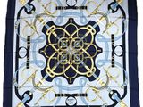 a blue and white square scarf with a gold and black design