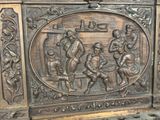 a bronze sculpture of a group of people on a bench
