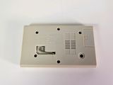 a small white electronic device on a white surface