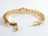 an image of a close up of a gold bracelet on a white surface