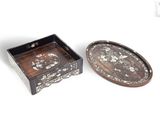 une paire de petits plateaux en bois ornés de motifs décoratifs