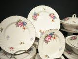 a lot of plates and cups on the table