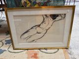 a picture of a drawing of a nude woman in a gold frame