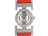 a close up of a watch on a white background with a red strap