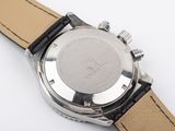 a close up of a watch on a white surface with a black strap