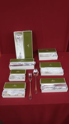 a table with a red table cloth and silverware on it