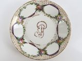 a white plate with a purple and green design on it