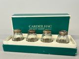 three glass salt and pepper shakers in a box on a table
