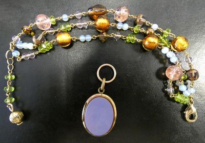 purple glass beaded necklace with gold plated clasp and multicolored glass beads