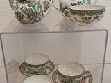 a display case with tea cups and saucers on it