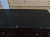 a black marble top dresser in a room