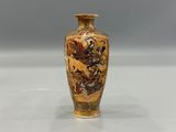 a vase with a dragon on it sitting on a table
