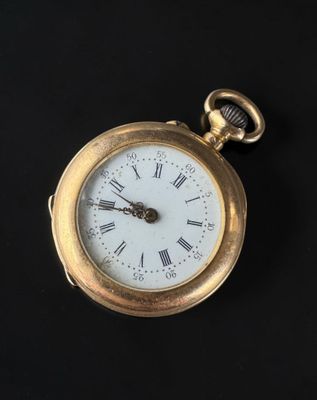 a gold pocket watch with roman numerals on it
