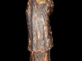 an old statue of a man holding a child in his arms