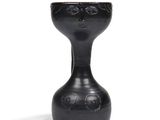 a black vase with a face on it on a white background