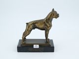 bronze statue of a dog on a marble base on a white background