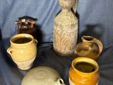 many different types of vases sitting on a blue cloth