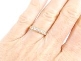 a woman ' s hand with a diamond ring on it