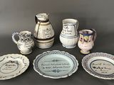 many different types of pottery on display on the table