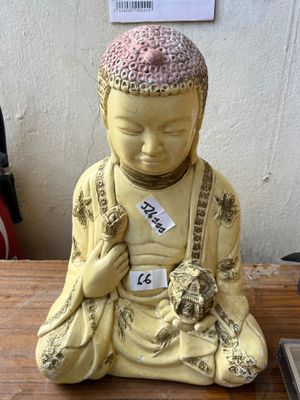 a small statue of a person sitting on a table