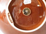 a brown vase that has a tag on it