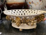 a white bowl with gold decoration on it on a table