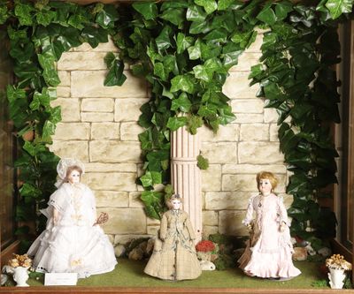 two figurines of a couple in a display case