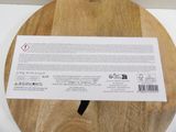 a wooden cutting board with a white label on it