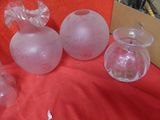 three glass vases on a table with a red cloth