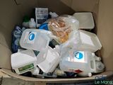 a cardboard box filled with plastic containers and containers