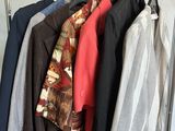 a lot of clothes hanging on a rack in a room