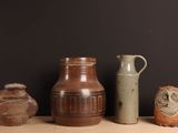 trois vases posés sur une table l'un à côté de l'autre