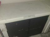 a white refrigerator with a pink ribbon on top of it