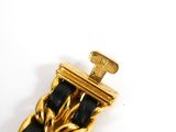 a close up of a gold and black bracelet