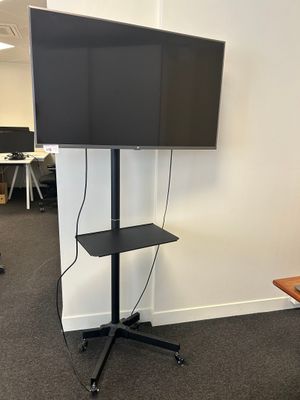 a flat screen tv on a stand in an office