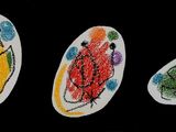 four oval shaped paper plates with different designs on them
