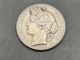 an old silver coin with a woman ' s head and a crown on it