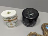 a cross, a box, and a cup sitting on a table