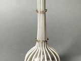 a white vase that is sitting on a table
