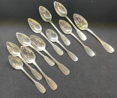 six silver spoons are lined up in a row on a black surface