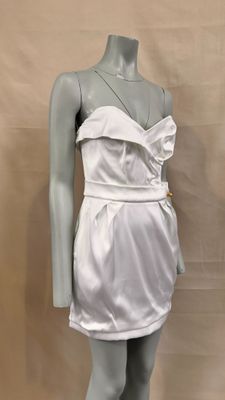a mannequin wearing a white dress on a mannequin stand