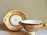 a cup and saucer sitting next to each other on a table