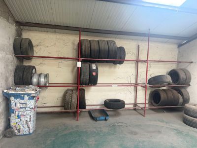 many tires on the shelves in the garage
