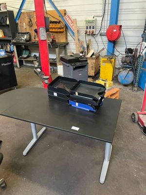 a black table with a laptop on it in a garage