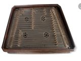 a wooden tray with holes in it on a white surface
