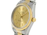 an image of a watch with a gold dial and two tone bracelet