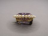 pearl and amethe ring with pearls on top of it
