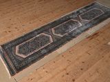 an image of a long rug on a wooden floor