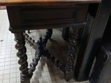 a small table with a wooden top on a tiled floor